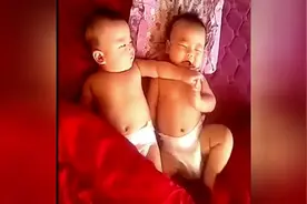 弟弟胳膊压在哥哥身上，哥哥的不甘示弱的反应真是太逗了！