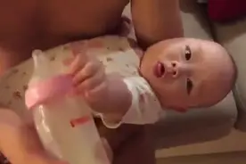 爸爸喂三个月的宝宝喝奶奶，一直喂一直推，就是不让爸比喂~~图片