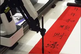 【视频】瞧，机器人拿起毛笔就写出一副对联图片