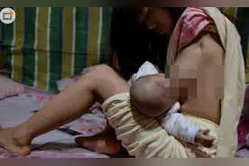无臂女孩两腿喂奶 被赞母爱的伟大图片