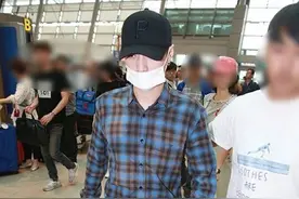 张艺兴低调现身机场回国 蓝色格子衬衣小清新而网友却关注一脚蹬图片