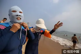青岛大妈“穿”脸基尼沙滩避暑 姿势各异表情轻松图片