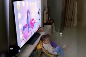 萌娃和爸爸面对面看电视走红，自娱自乐互不打扰，最熟悉的陌生人图片