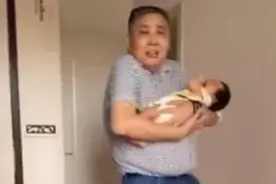 姥爷抱外孙的照片火了，动作僵硬表情惶恐，网友：这娃“烫手”？图片