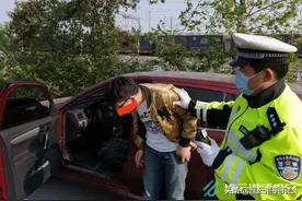 酒后开车犯迷糊，滚滚车流路边睡图片