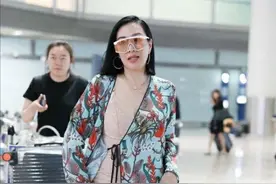 49岁“晚娘”钟丽缇，穿着睡衣就敢走机场，走路带风衣角飞扬图片