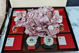 郑州公交司机捡到月饼礼盒，打开一看里面竟有百张叠成心形的百元大钞！背后的故事很浪漫图片