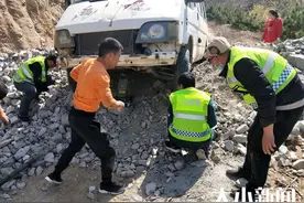 重型工程车卡在土堆上 烟台救援队员徒手扒土救援图片