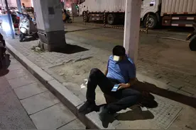 喝醉了，他坐在路边玩手机时竟然睡着了……图片