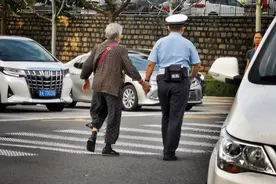 「钱眼2020」牵手：济南一位交警牵着白发老人的手过马路图片