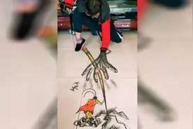 51秒丨大写的服！与自己身体巧妙结合 小伙在地上画出立体3D沙画图片