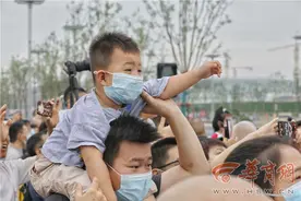 火炬传递进行中 3岁萌娃向火炬手挥手连呼“加油”图片
