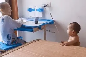 妹妹拿小棍模仿妈妈训斥哥哥，认真模样，遗传到妈妈的精髓图片