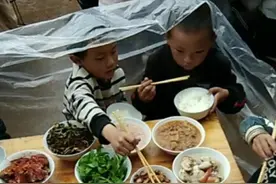 云南农村下雨天请客，一群儿童围雨布吃席，网友：穷到你不敢想象图片