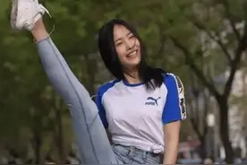 小姐姐穿“拼色短袖”和“活力牛仔裤”，当街一字马，柔韧性十足图片