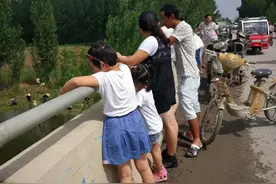 暴雨过后，上百人在桥上捕鱼，很多村民活也不干了，到现场围观图片
