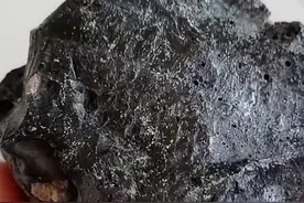 石头发绿色，微磁性，有好多小气孔，很重