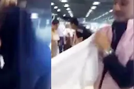 有点拼！为省行李超重费 男子不顾炎热现场开箱穿上15件衣服视频封面