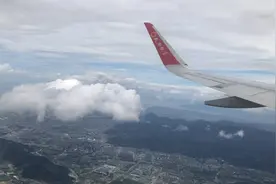 飞机从温州机场起飞跃入云层，俯瞰舷窗外的温州城市风光