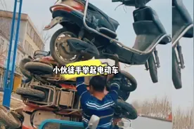 小伙徒手举起电动车