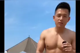 大胸肌肉男体育老师在沙滩上海边晒太阳视频封面