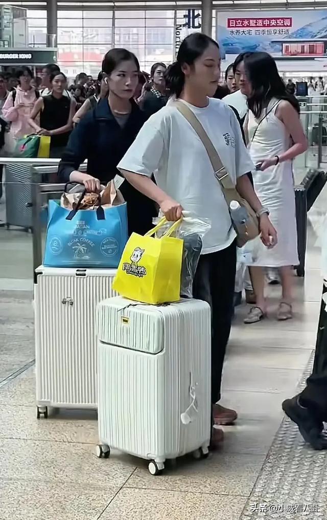 女民兵拉着五颜六色拉杆箱返程，阅兵靴子没来得及换，穿衣很时尚