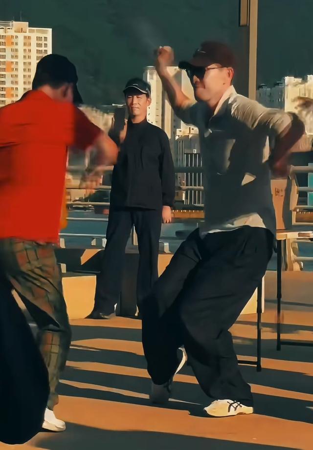 王千源带女儿韩国度假，打扮年轻跟大妈跳广场舞，长得凶但人特逗