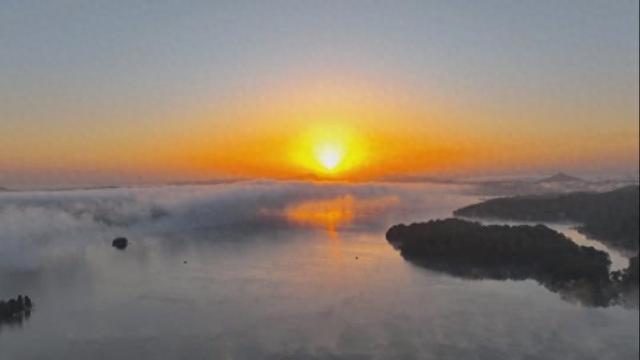 江西新余：雾锁仙湖迎日出 金光漫洒入画来