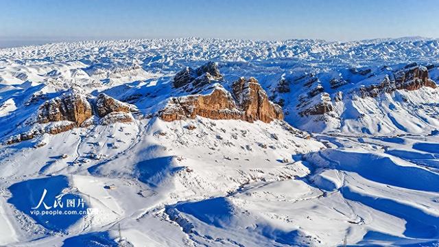 新疆呼图壁：雪映丹霞 展现壮美冬日画卷