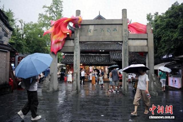 成都：暑期游客雨中游览锦里古街