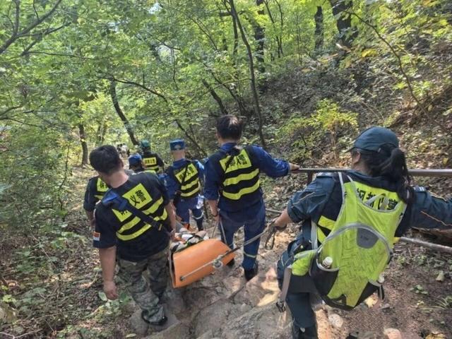 爬山崴脚游客不能动 志愿者轮流抬下山