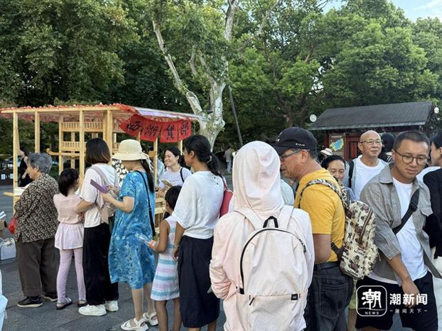西湖边的“空瓶换荷花”太圈粉，兑换点排起长队，半小时就兑换出大部分