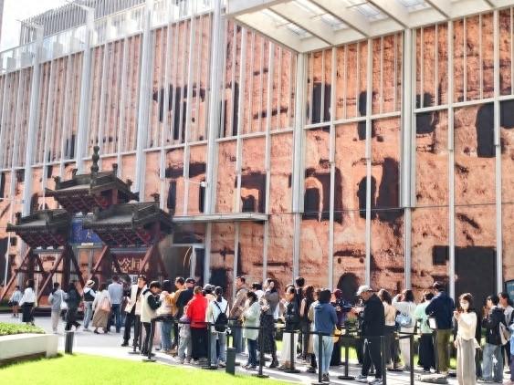 打卡莫高窟牌坊、看洞窟壁画…“何以敦煌·念念回响”公益展首个周末观众过万