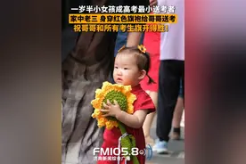 6月7日，山东济南，在省实验中学考点，一岁半的小女孩成高考考场外的最小送考者，身穿红色旗袍的她给哥哥送考，希望哥哥和所有考生旗开得胜！