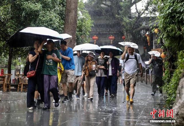 成都：暑期游客雨中游览锦里古街