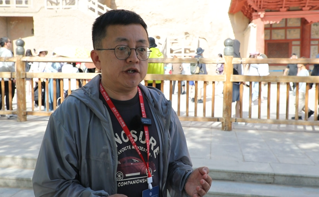 “丝路之光·何以敦煌”国际媒体采风团嘉宾探访千年莫高