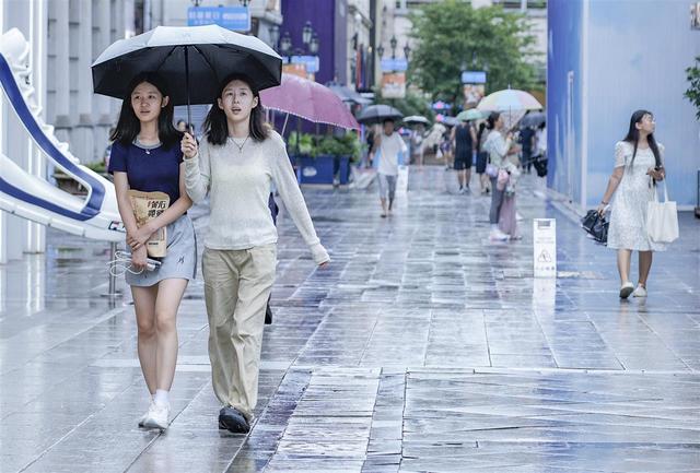 游客逛街，享受雨天清凉