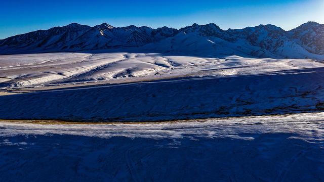 在黑山草原，邂逅淡蓝雪影与鎏金峰顶的浪漫
