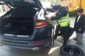 轿车在收费站爆胎，高速工作人员迅速帮忙更换轮胎图片