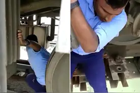 因乘客拉动紧急制动装置，印度一火车副驾驶员冒险钻车底重置旋钮图片