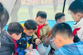 小学生在帐篷里享受阅读 校园露营式读书节受热捧图片