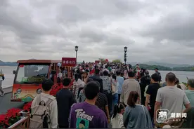 雨西湖魅力不减，西湖边人人人人人，坐船排队起码半小时起步图片