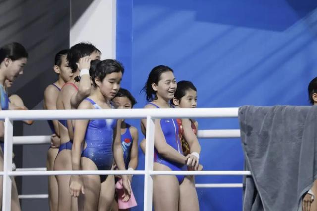 全红婵时隔五月重返赛场，出战女子团体双人10米台，第一跳结束后排名第一，看台上都是为她加油的海报