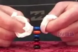 活久见！澳大利亚一 #男子成功堆叠6个MM豆打破吉尼斯世界纪录 