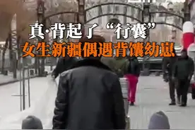 #背起行囊在新疆是写实 3月9日，新疆霍尔果斯。女生下楼买菜偶遇人类幼崽背馕：馕对于新疆人来说必不可少，这么大的馕也是很常见的。有新疆ip网友表示这是“时尚单品”。